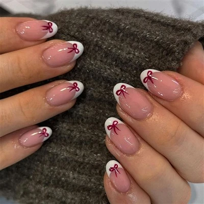 Uñas francesas para el día de San Valentín con lazos rojos